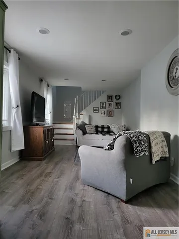 a living room with couches and a flat screen tv