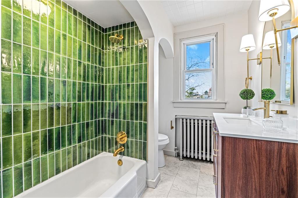 114 Augusta Street Pittsburgh, PA 15211 - Photo 3 of 32 a bathroom with a sink a mirror and a bathtub