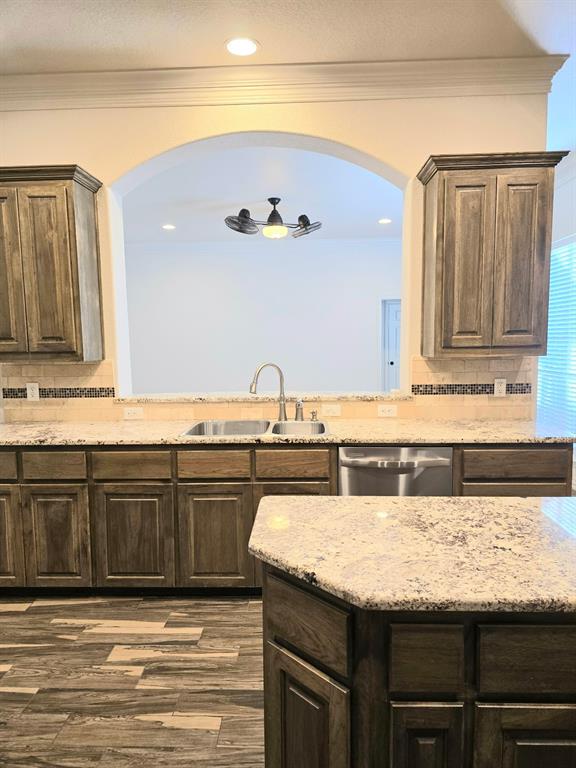 7 Southfork Court Wichita Falls, TX 76310 - Photo 11 of 27 a kitchen with granite countertop a sink and cabinets