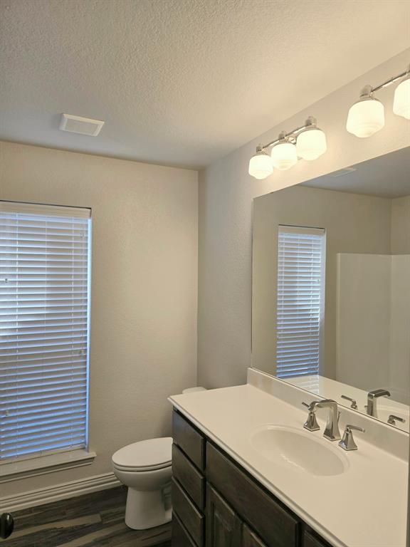 7 Southfork Court Wichita Falls, TX 76310 - Photo 17 of 27 a bathroom with a sink a toilet and mirror