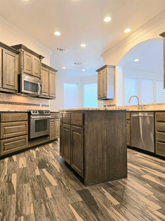 7 Southfork Court Wichita Falls, TX 76310 - Photo 10 of 27 a kitchen with stainless steel appliances granite countertop a stove a sink and a microwave