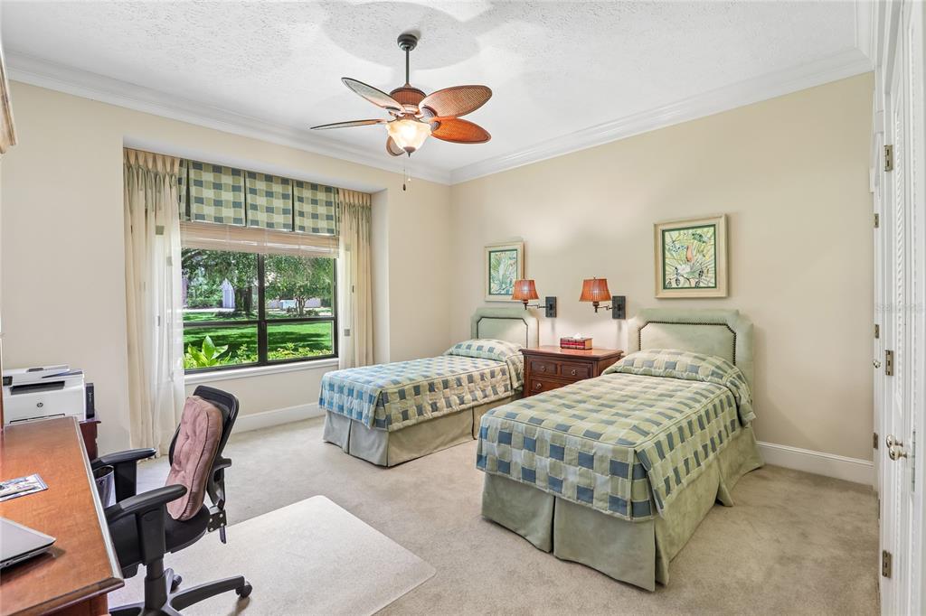 17810 Crawley Road Odessa, FL 33556 - Photo 28 of 76 a bedroom with two beds and a large window