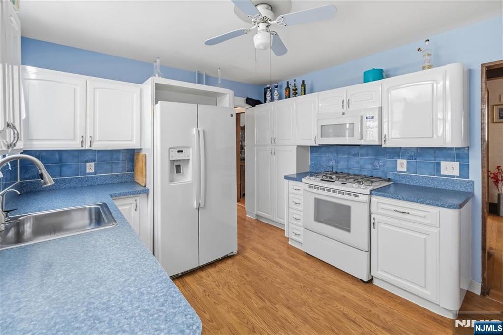 119 Overpeck Avenue Ridgefield Park, NJ 07660 - Photo 12 of 44 a kitchen with granite countertop a sink cabinets and stainless steel appliances