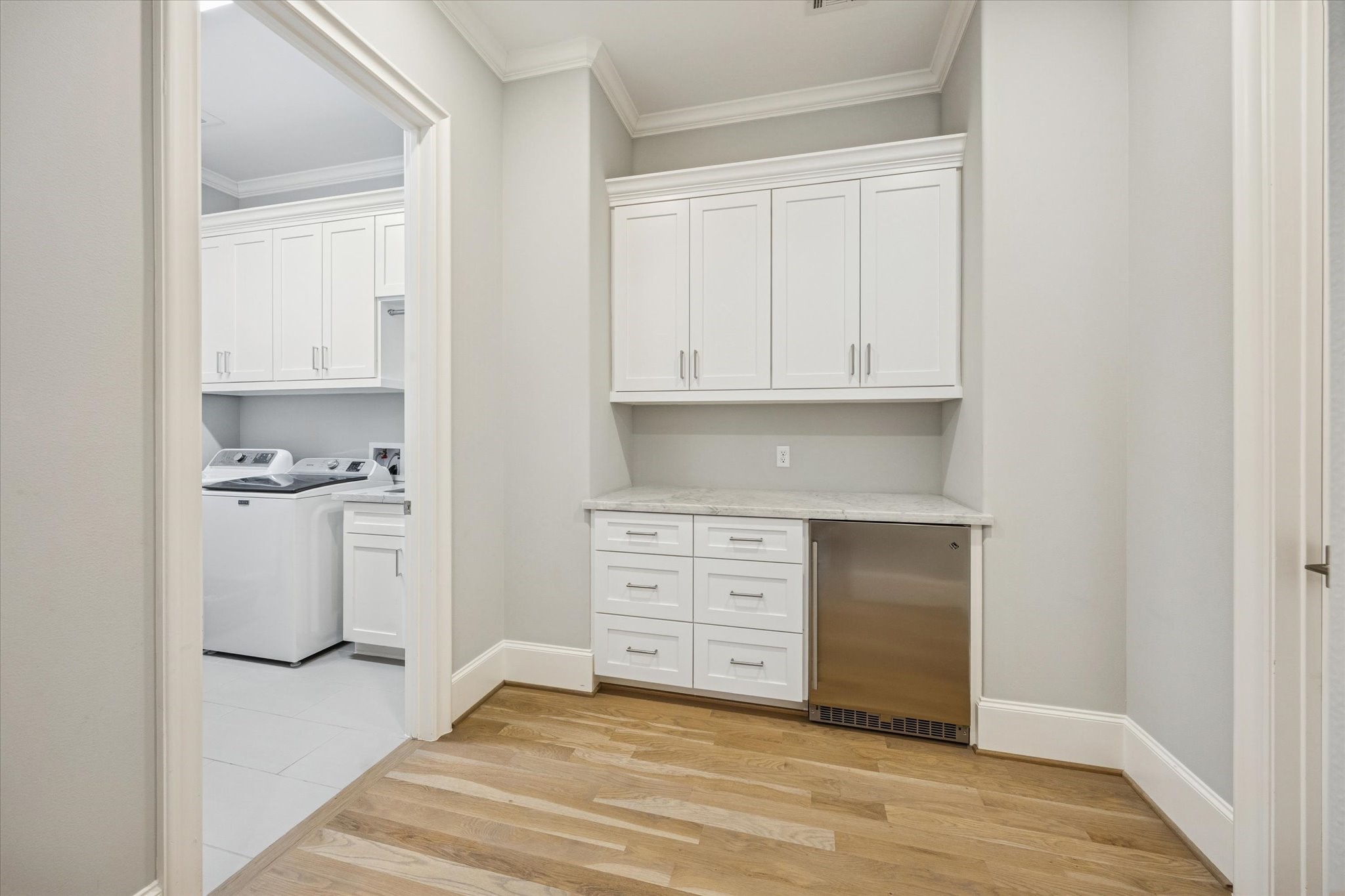 4108 Sunset Boulevard Houston, TX 77005 - Photo 19 of 21 Utility room features sink and built-in cabinetry. Second floor beverage fridge and plenty of storage.