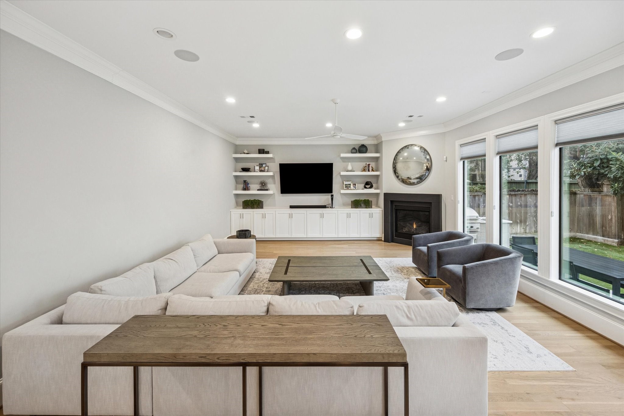 4108 Sunset Boulevard Houston, TX 77005 - Photo 3 of 21 An open-concept living space with a fireplace and abundant natural light. Oversized windows overlooking the backyard.