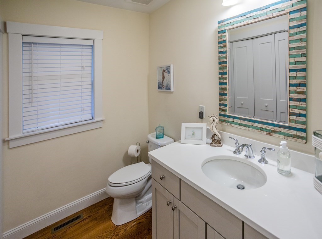 1301 Service Road Barnstable, MA 02668 - Photo 17 of 40 a bathroom with a sink toilet and a mirror