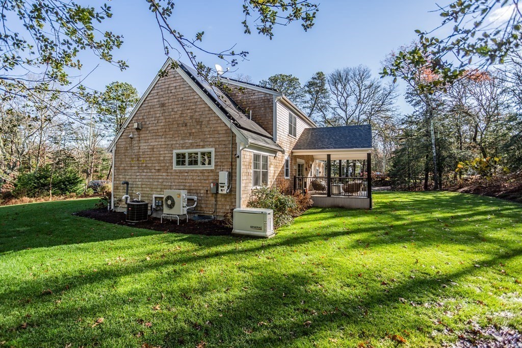1301 Service Road Barnstable, MA 02668 - Photo 37 of 40 a view of a house with a yard porch and sitting area