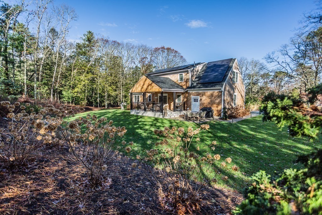 1301 Service Road Barnstable, MA 02668 - Photo 38 of 40 a view of a house with a big yard and large trees