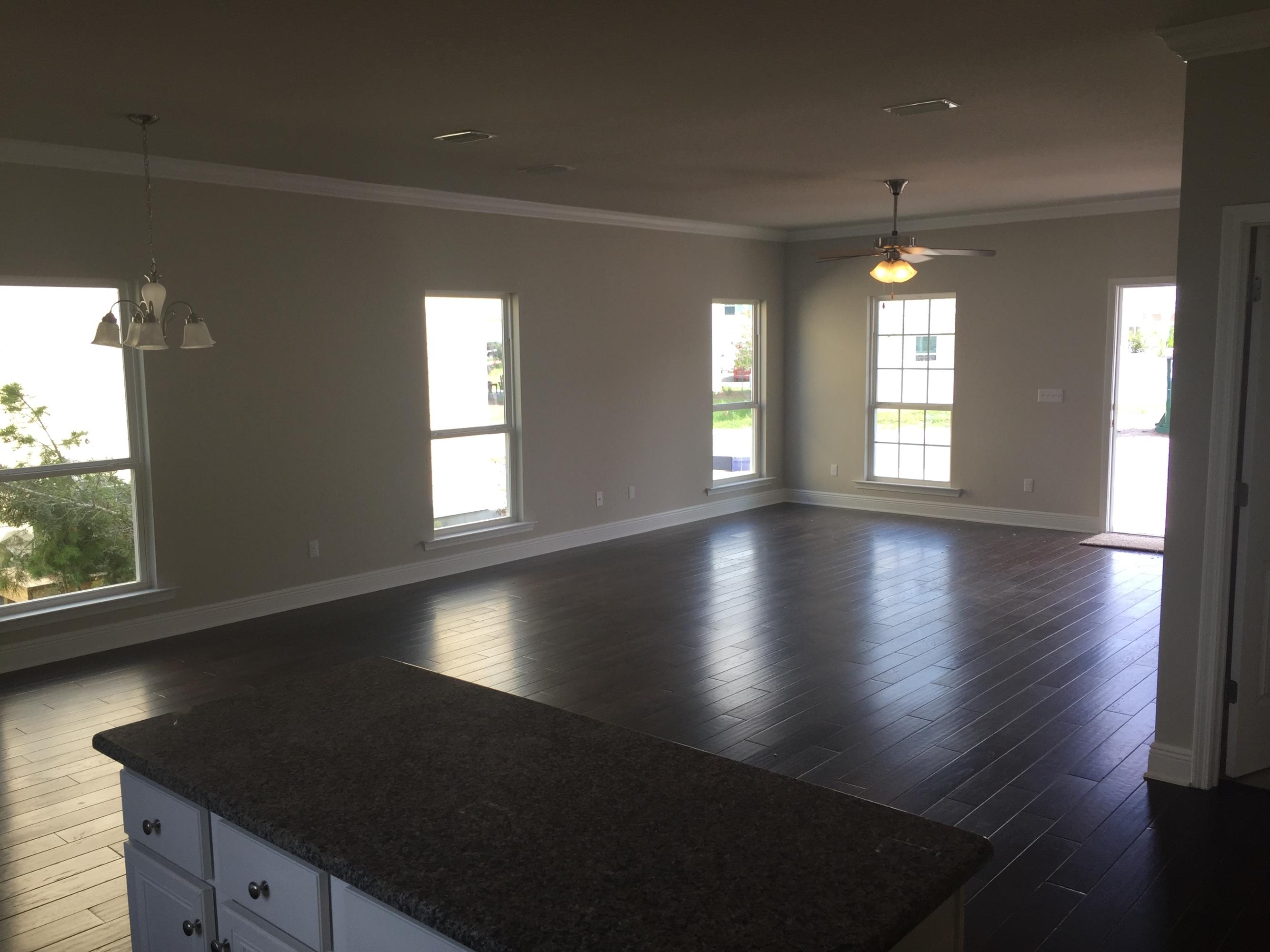 49 Grayling Way Inlet Beach, FL 32461 - Photo 8 of 10 an empty room with wooden floor and windows