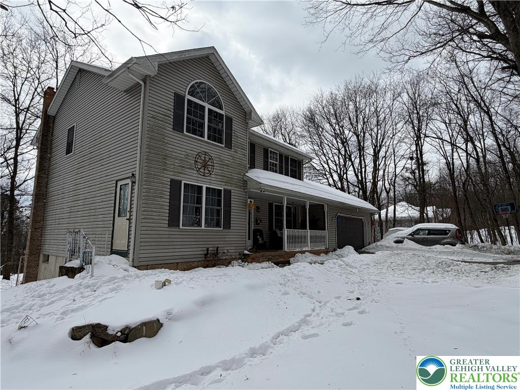 303 East Mountain Top Road Summit Hill, PA 18250 - Photo 3 of 31 a front view of a house with a yard covered in snow