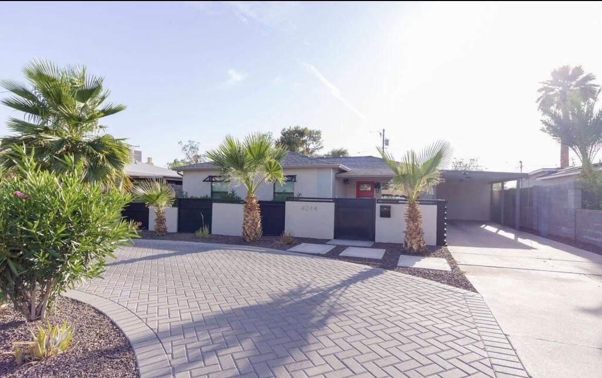4214 North 20th Street Phoenix, AZ 85016 - Photo 2 of 40 a front view of a house with a yard and a garage
