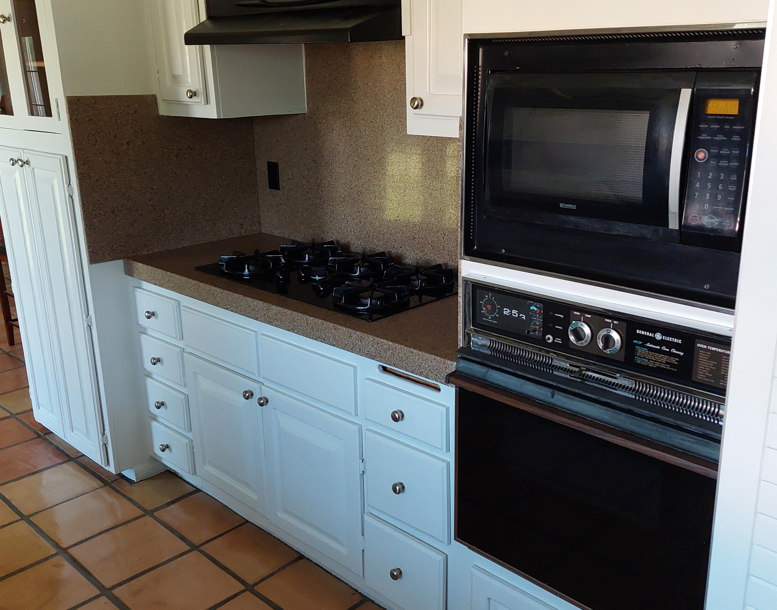 42710 Sandy Bay Road Bermuda Dunes, CA 92203 - Photo 11 of 37 a kitchen with microwave cabinets and stove top oven
