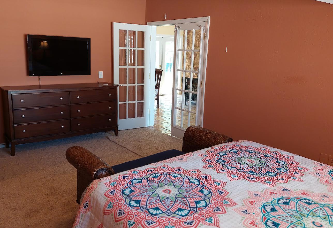 42710 Sandy Bay Road Bermuda Dunes, CA 92203 - Photo 16 of 37 a bedroom with a bed and flat screen tv