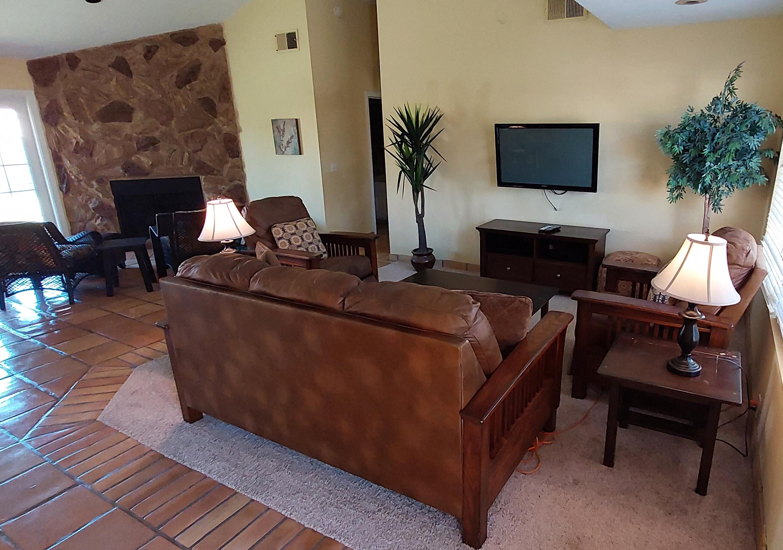 42710 Sandy Bay Road Bermuda Dunes, CA 92203 - Photo 5 of 37 a living room with furniture a fireplace and a flat screen tv