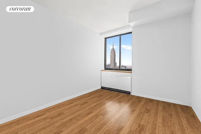 a kitchen with stainless steel appliances granite countertop a refrigerator a stove and a sink with wooden floor