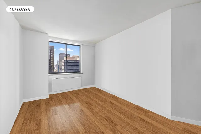 a bedroom with bed and a potted plant