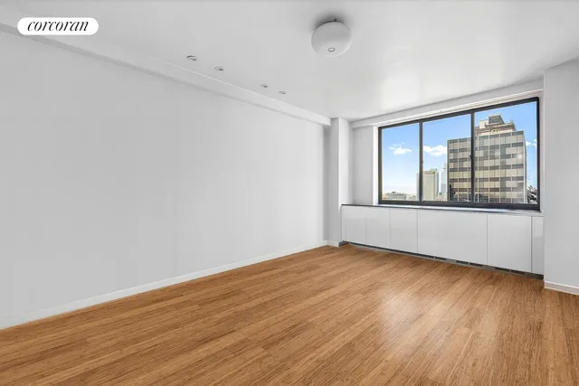 a bedroom with bed and a potted plant