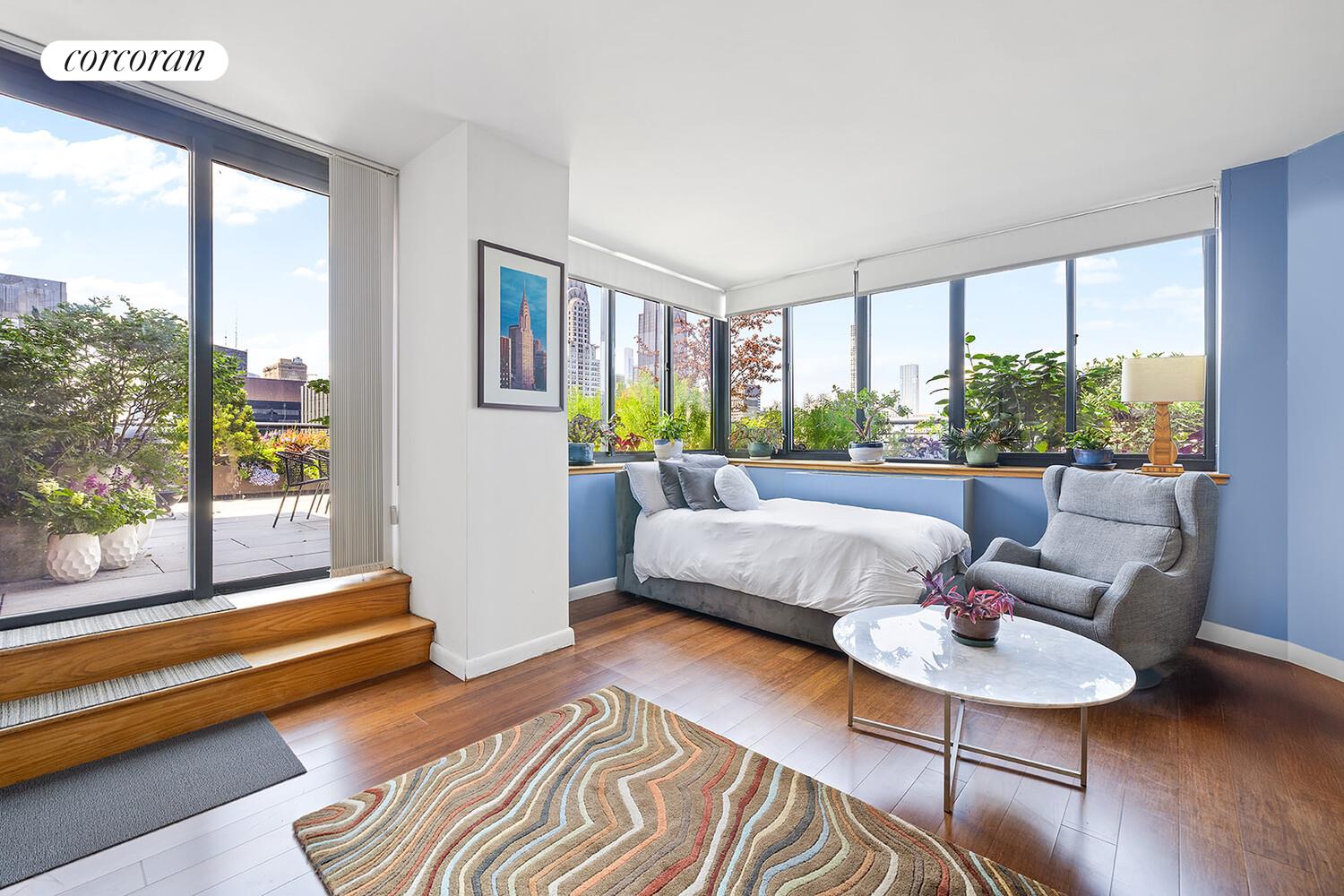 250 East 40th Street, Unit PH2A Manhattan, NY 10016 - Photo 16 of 25 a living room with furniture and a large window