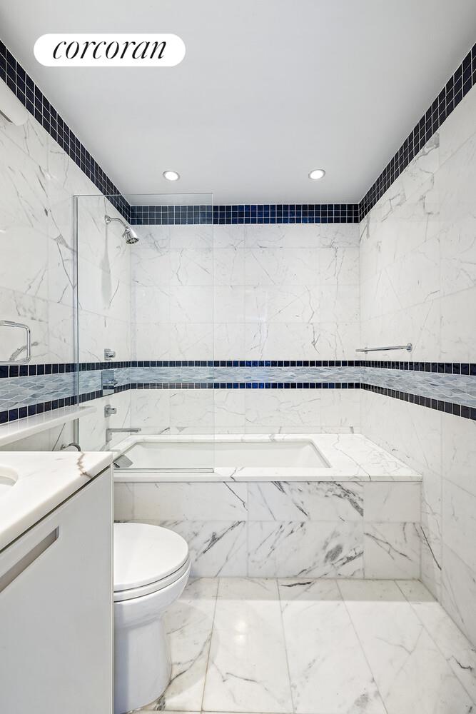 250 East 40th Street, Unit PH2A Manhattan, NY 10016 - Photo 18 of 25 a bathroom with a toilet a sink and a bathtub