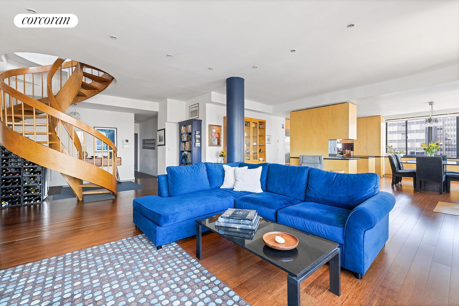 250 East 40th Street, Unit PH2A Manhattan, NY 10016 - Photo 6 of 25 a living room with furniture and a dining table with wooden floor
