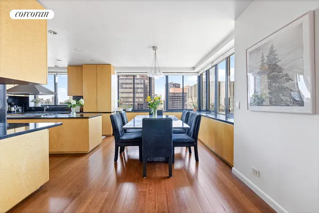 a living room with furniture and a dining table with wooden floor