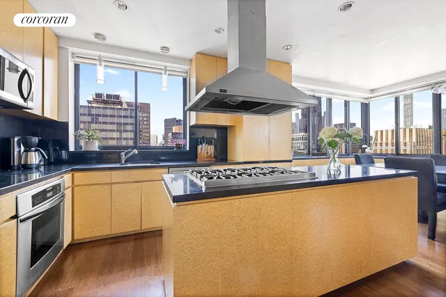 a dining room with furniture a chandelier and wooden floor