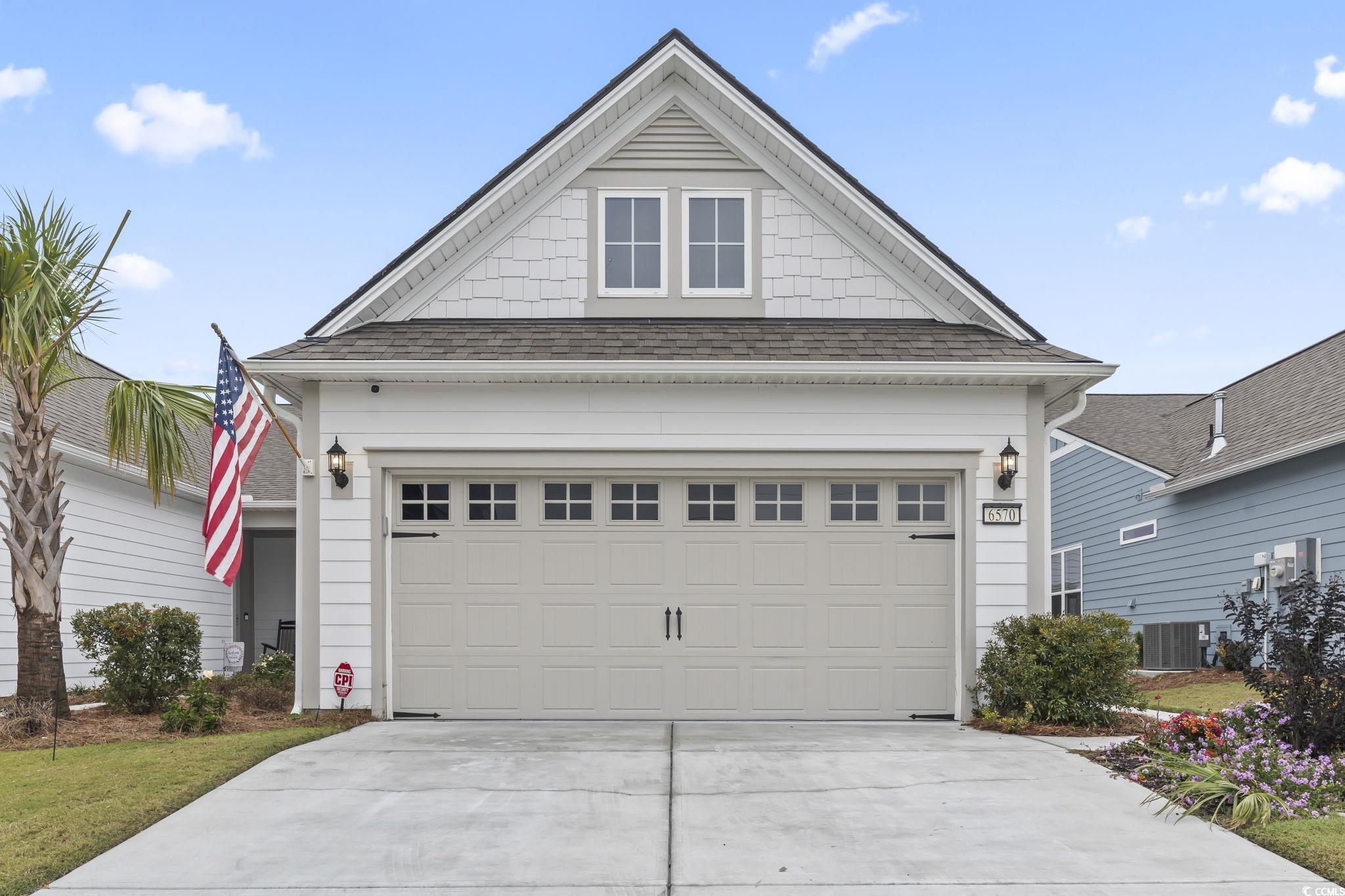 6570 Torino Lane Myrtle Beach, SC 29572 - Photo 18 of 25 View of front facade featuring roof with shingles, a garage, and driveway
