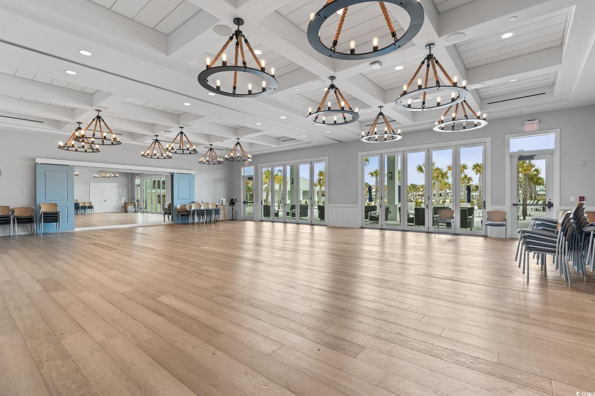 6570 Torino Lane Myrtle Beach, SC 29572 - Photo 22 of 25 Gathering room with beam ceiling, recessed lighting, coffered ceiling, a chandelier, and french doors.