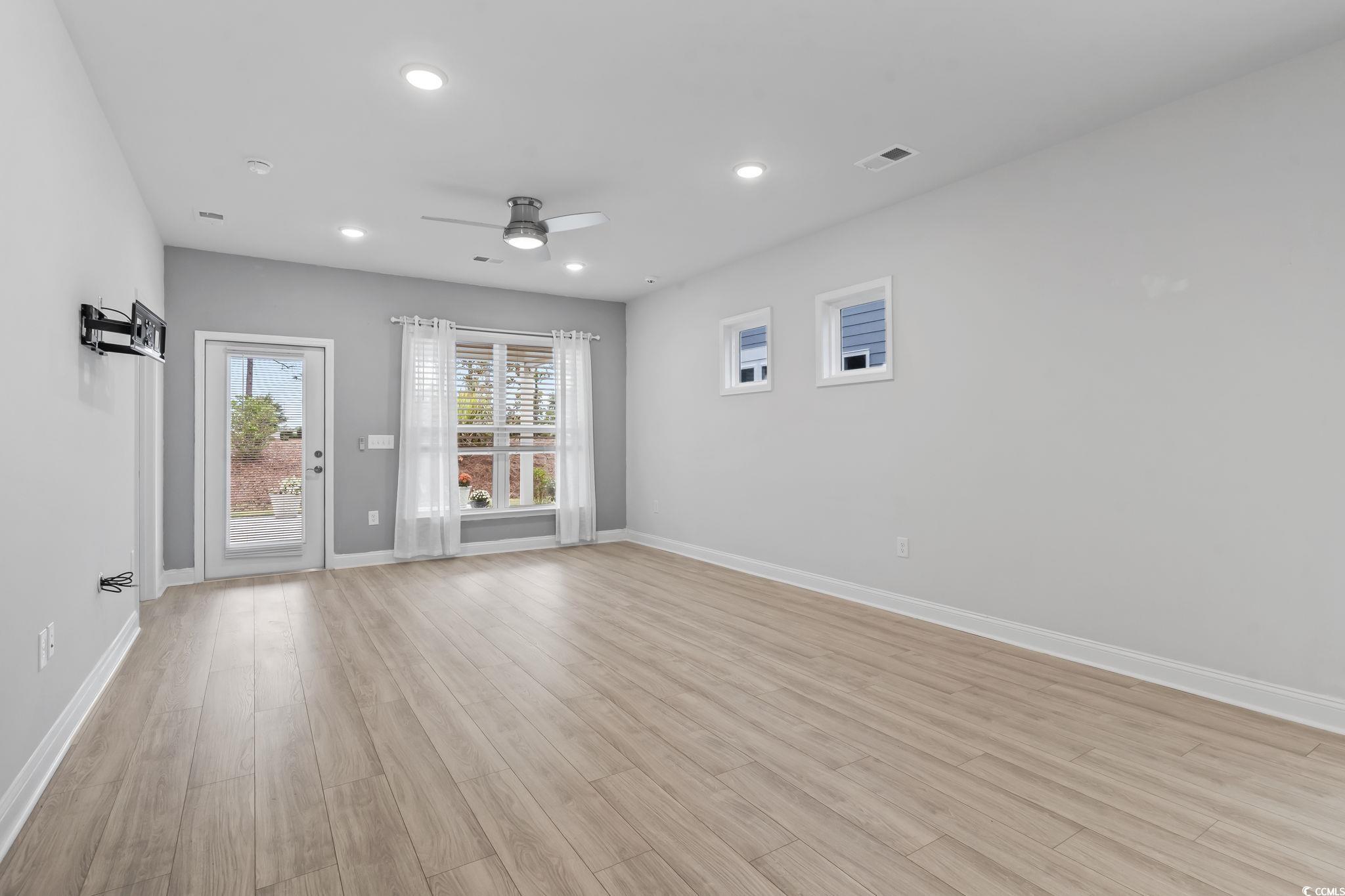 6570 Torino Lane Myrtle Beach, SC 29572 - Photo 2 of 25 Living/dining/kitchen room with light wood finished floors, recessed lighting, and a ceiling fan
