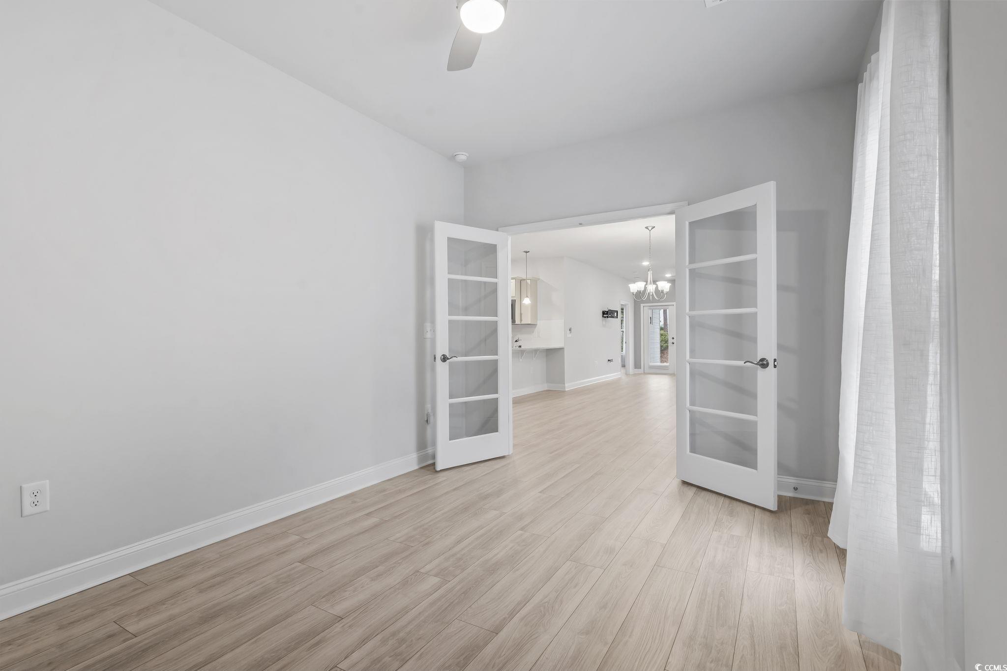 6570 Torino Lane Myrtle Beach, SC 29572 - Photo 8 of 25 Flex room with a chandelier, french doors, light wood-type flooring, and a ceiling fan