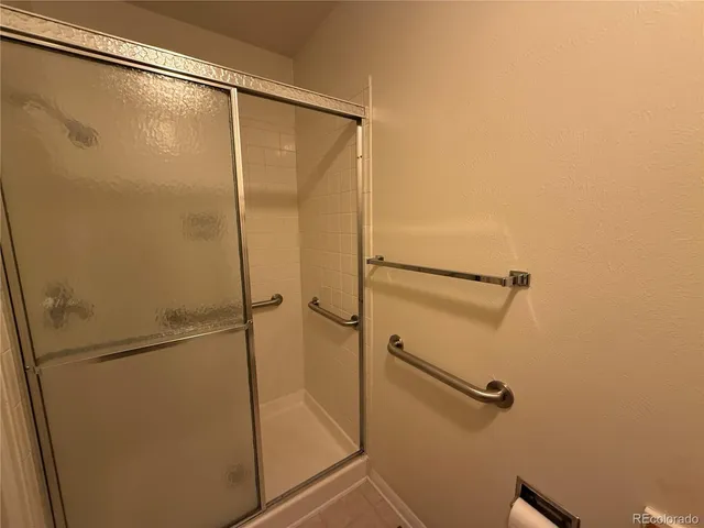 a bathroom with a toilet and a shower