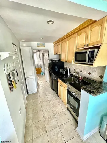 a kitchen with stainless steel appliances granite countertop a stove microwave and sink