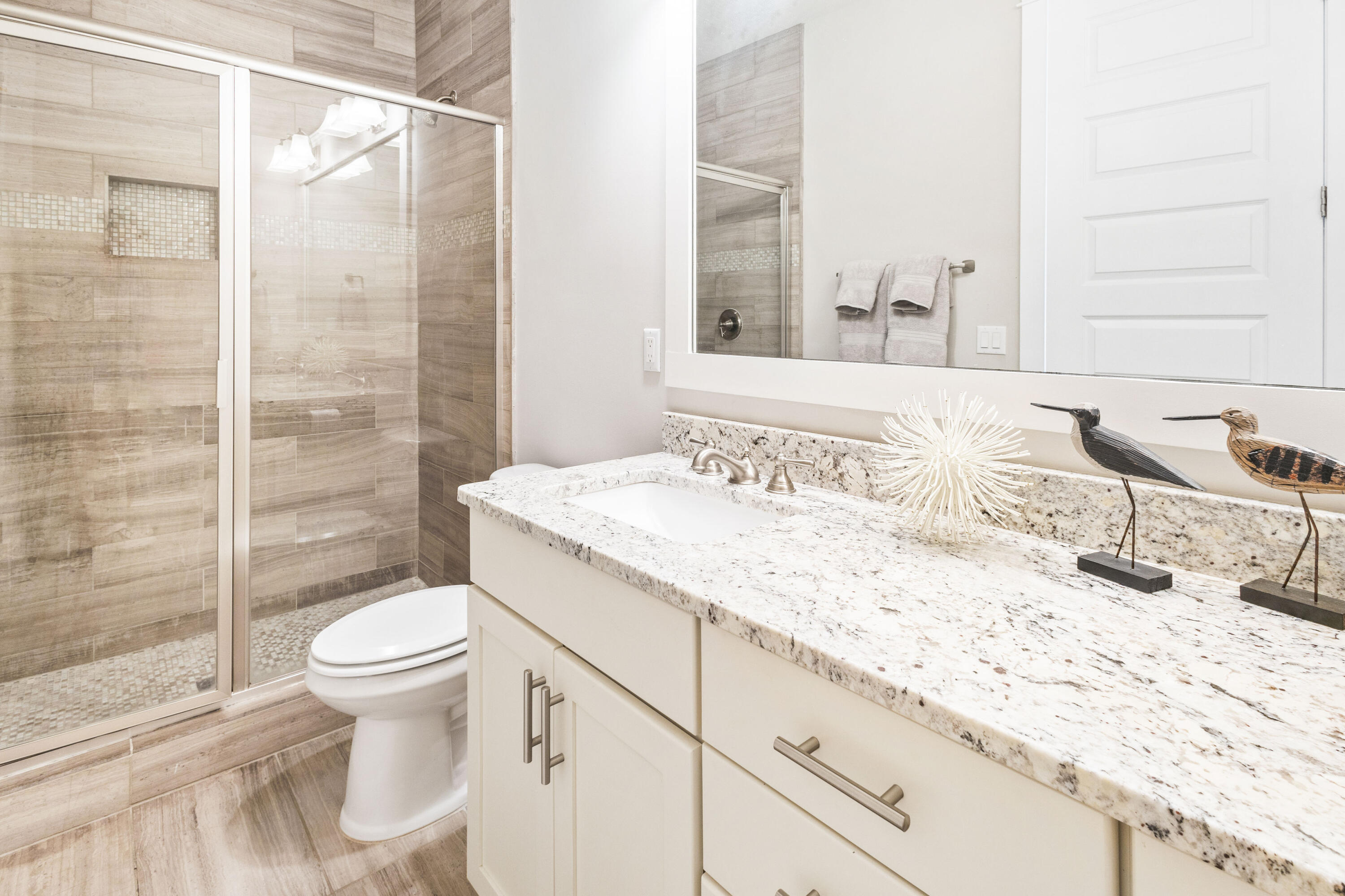 48 Pleasant Street Inlet Beach, FL 32461 - Photo 42 of 60 a bathroom with a granite countertop sink a toilet and shower