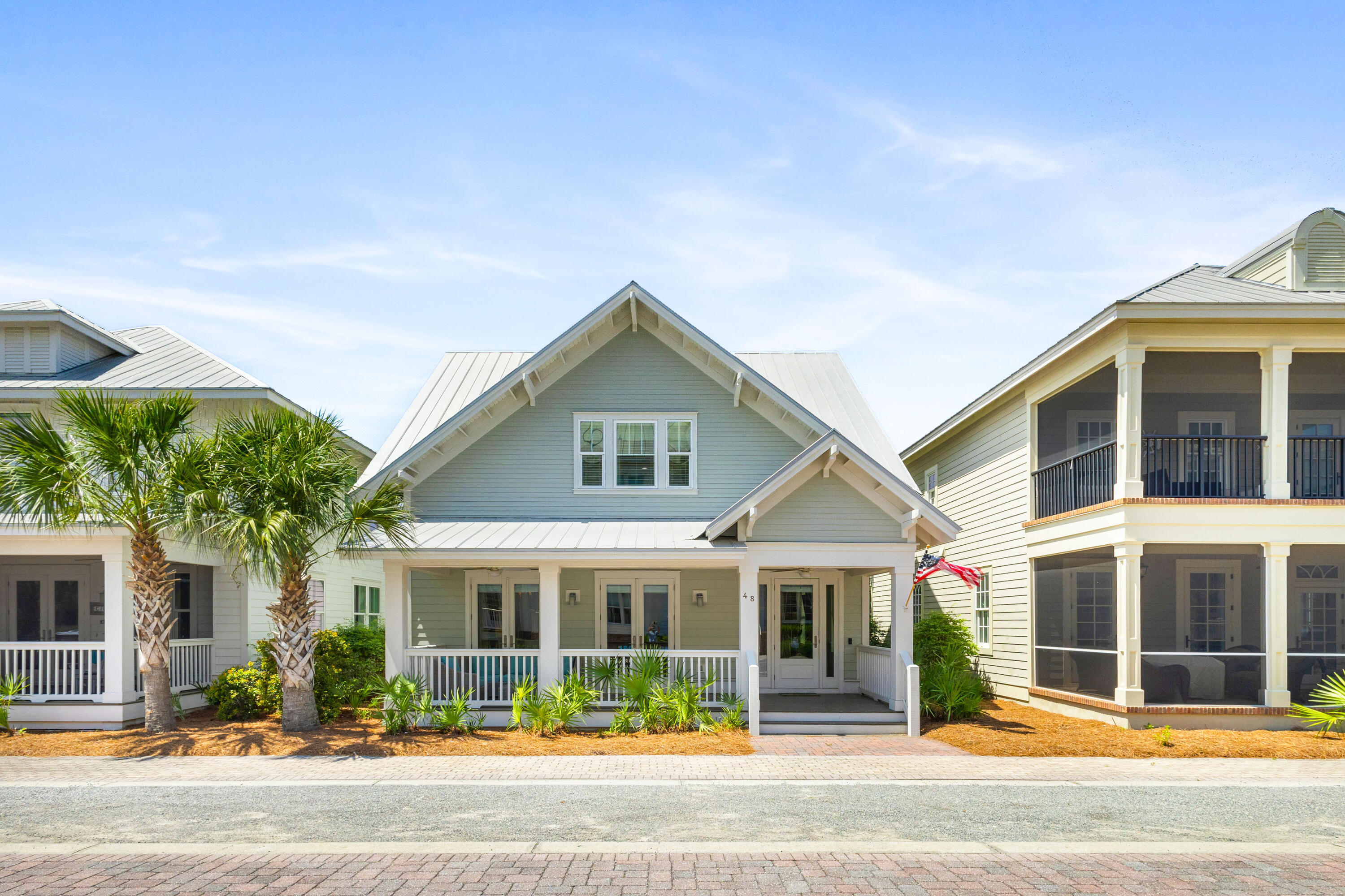 48 Pleasant Street Inlet Beach, FL 32461 - Photo 48 of 60 a view of a white house with a large windows and a yard with plants and large tree