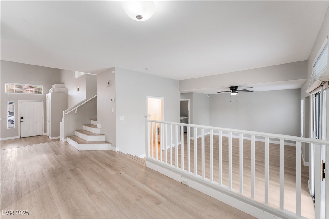 3695 Funston Way Las Vegas, NV 89129 - Photo 9 of 43 Corridor featuring healthy amount of natural light, stairs, and light wood-style floors