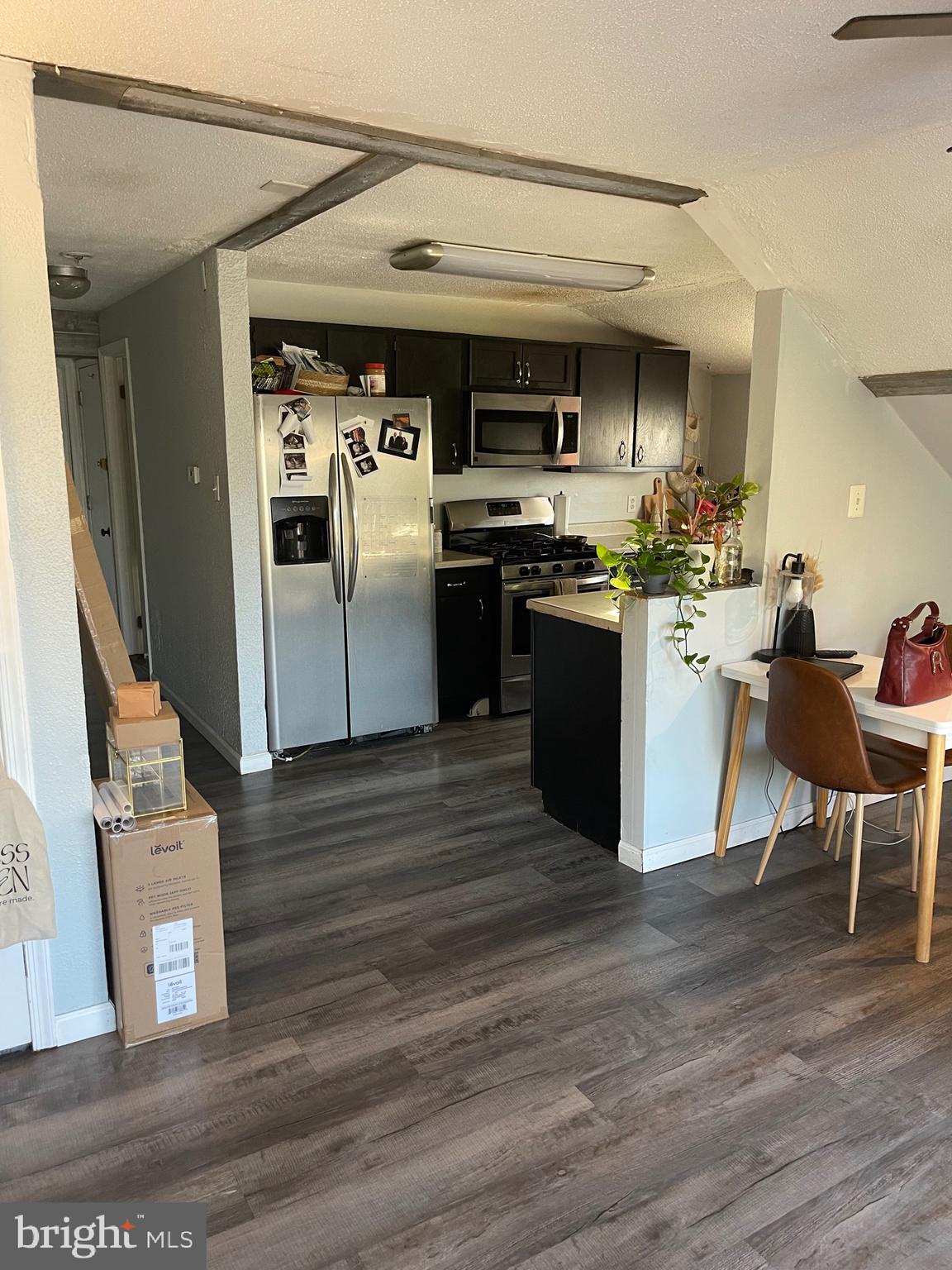 368 Pitman Avenue Pitman, NJ 08071 - Photo 13 of 22 a kitchen with stainless steel appliances kitchen island granite countertop a table chairs and a refrigerator