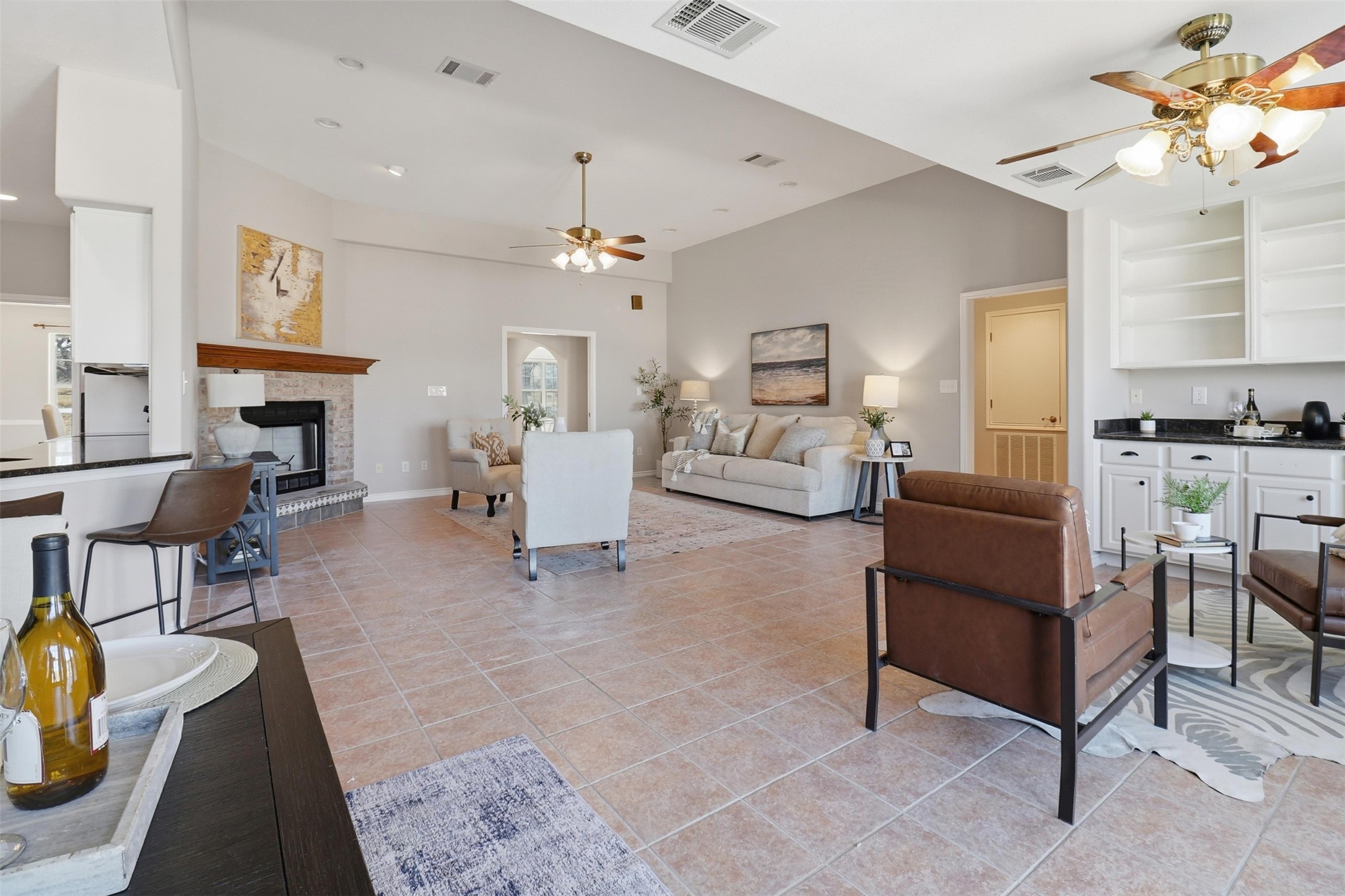 200 Apache Trail Burnet, TX 78611 - Photo 13 of 40 Living area featuring a ceiling fan, a fireplace, and light tile patterned flooring