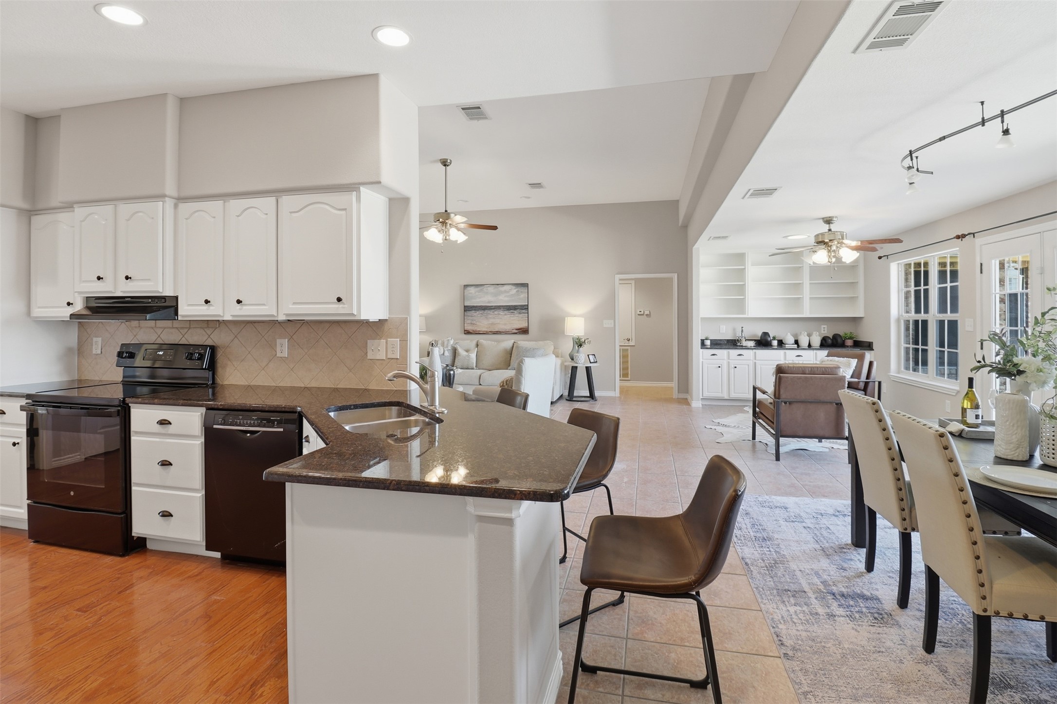 200 Apache Trail Burnet, TX 78611 - Photo 40 of 40 Kitchen with black appliances, dark stone counters, a breakfast bar, open floor plan, and a peninsula