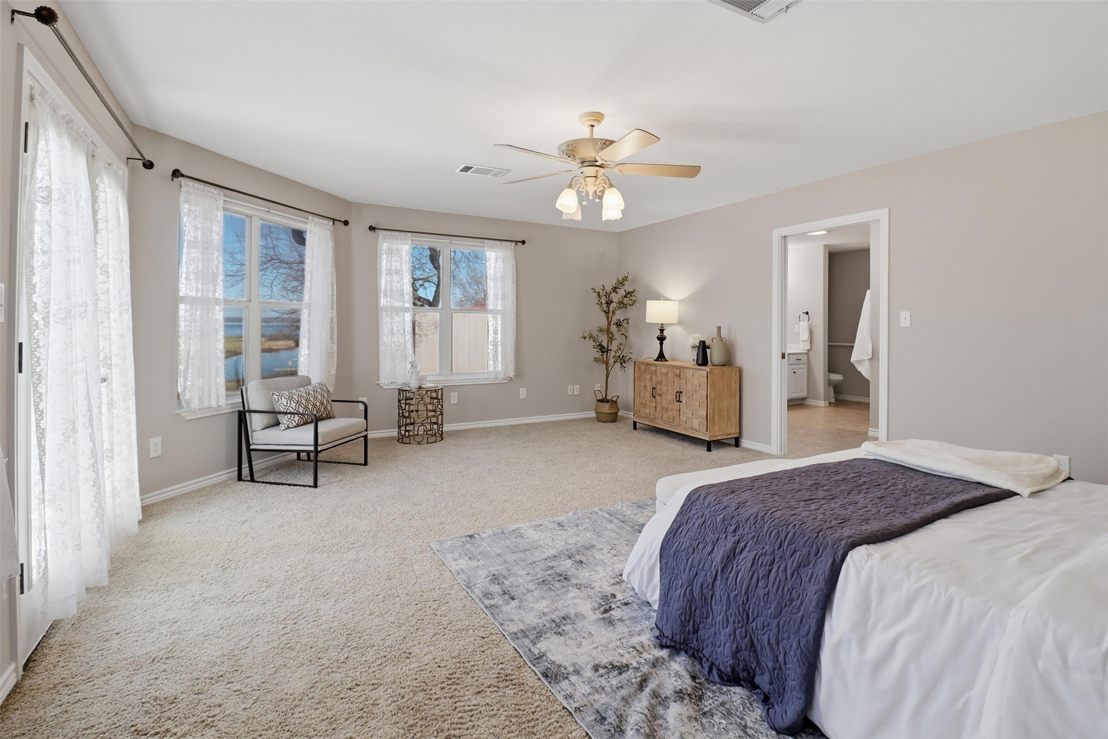 200 Apache Trail Burnet, TX 78611 - Photo 18 of 40 Carpeted bedroom featuring a ceiling fan and ensuite bath