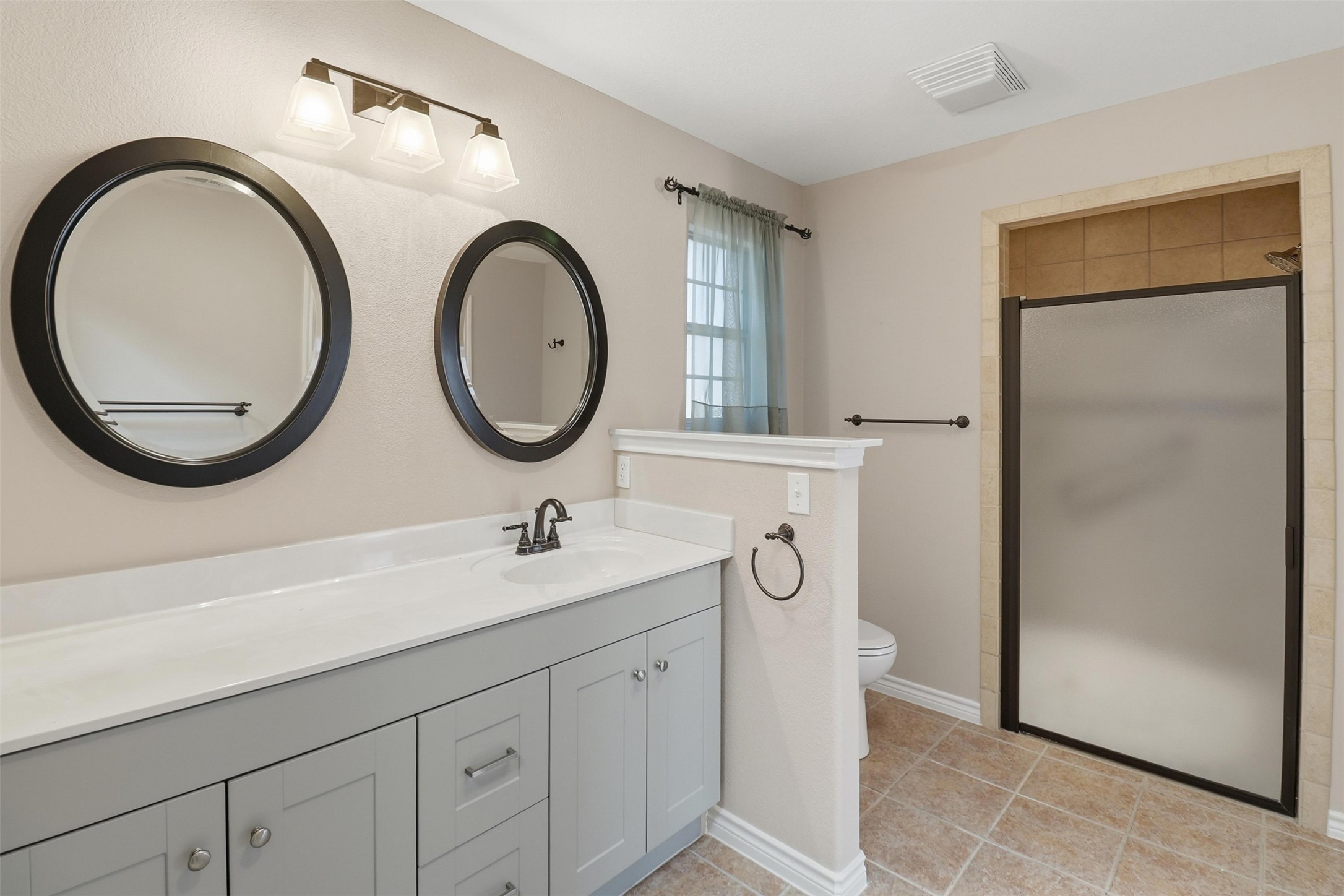 200 Apache Trail Burnet, TX 78611 - Photo 24 of 40 Full bathroom featuring vanity, a stall shower, and light tile patterned floors