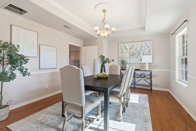 a view of a dining room with furniture window and wooden floor