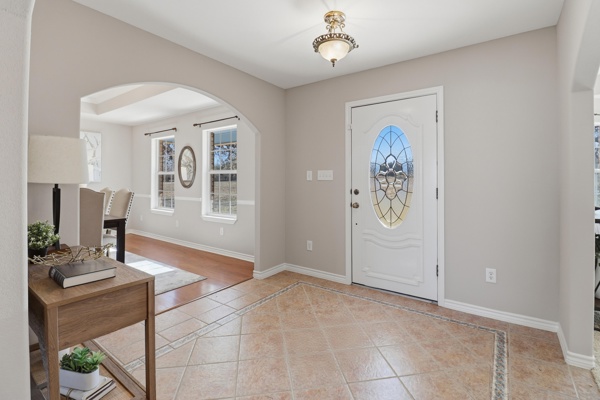 200 Apache Trail Burnet, TX 78611 - Photo 3 of 40 Entryway featuring arched walkways, inlaid floor details, and light tile patterned floors