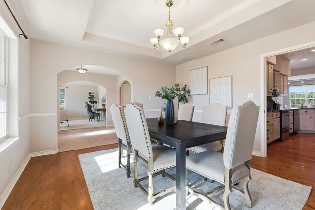a view of a dining room with furniture and wooden floor