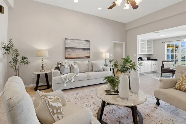 a living room with furniture and a chandelier