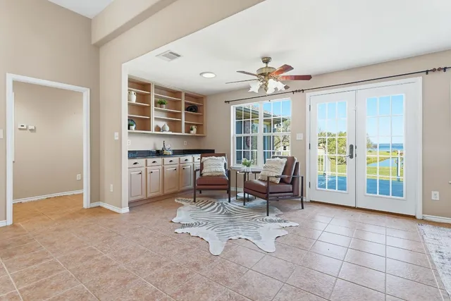 a living room with furniture and large windows