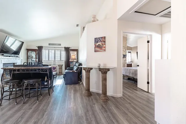 a living room with furniture and a wooden floor