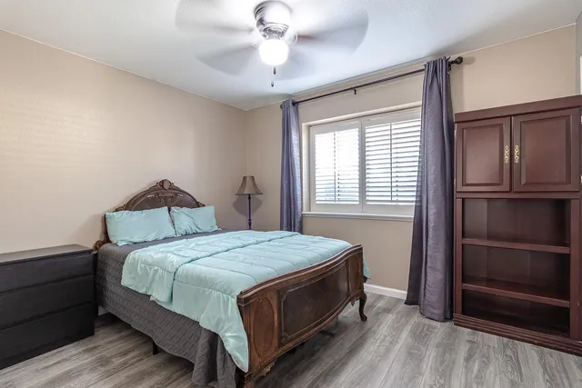 a bedroom with a bed and a window