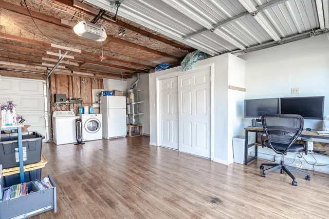 a living room with lots of furniture and a kitchen view