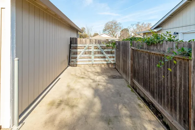 a view of balcony with wooden floor and fence