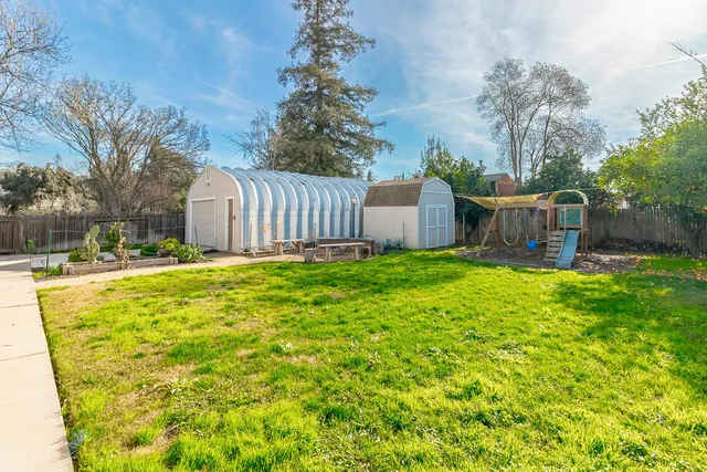 a view of a backyard with a small garden